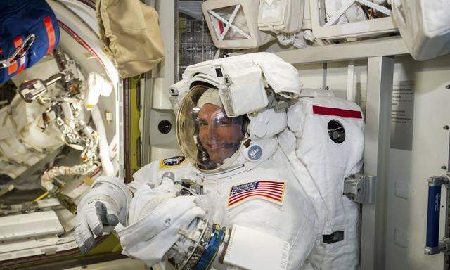 NASA astronaut Reid Wiseman checks his spacesuit in preparation for the first Expedition 41 spacewalk
