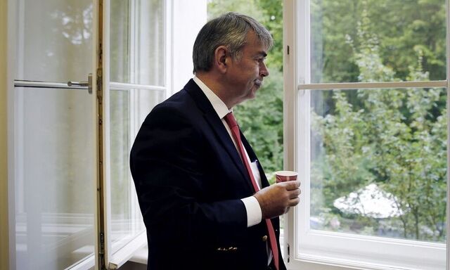Mollath looks out of a window before the verdict in his retrial at a court in Regensburg