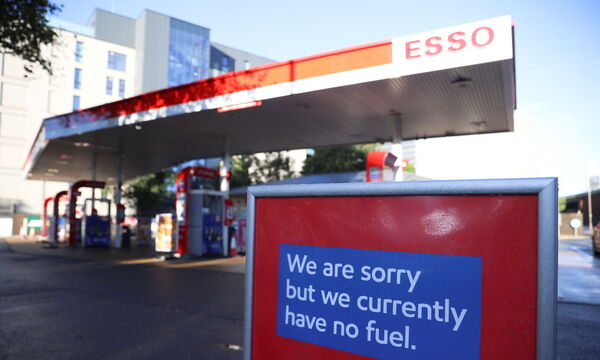 A sign informing customers that fuel has run out is pictured at a Esso fuel station in London