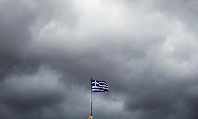 A Greek national flag flutters atop the Athens' University