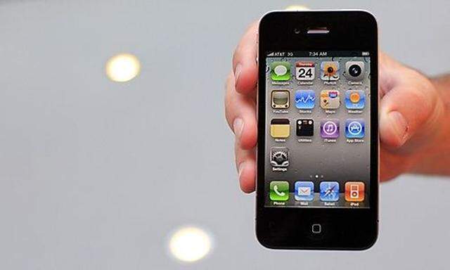 Customer displays an iPhone 4 purchased at the Apple Store 5th Avenue in New York