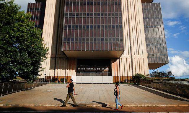 People walk in front the Central Bank headquarters building in Brasilia