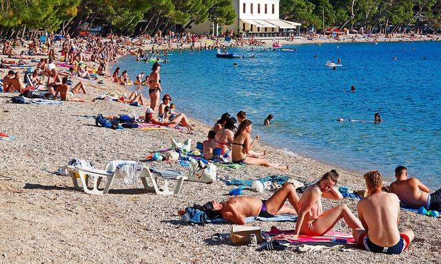Beach in Makarska, Croatia Tourists enjoy on the beach in Makarska, Croatia, on June 27, 2020. The number of tourists i