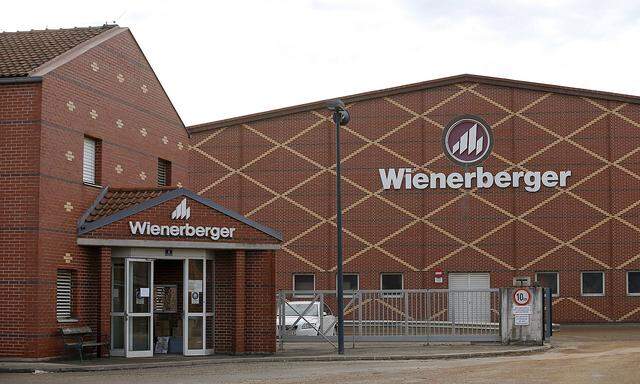 Logos of Wienerberger, the world's biggest brickmaker, are pictured at its headquarters in Hennersdorf