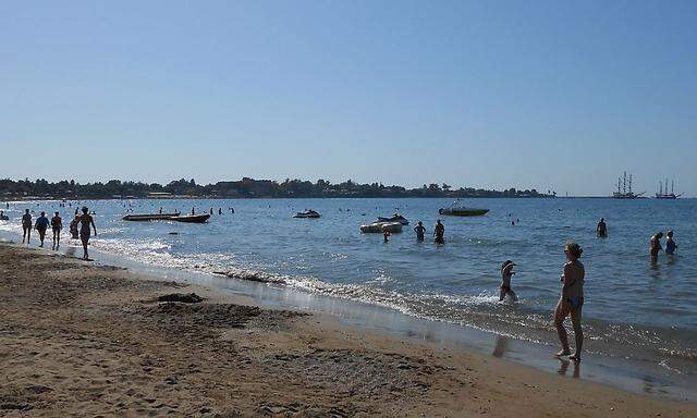 People are seen on the east beach in Side