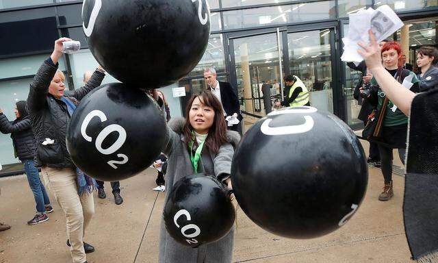 Activists protest against the carbon dioxide emissions trading in front of the World Congress Centre Bonn, the site of the COP23 U.N. Climate Change Conference, in Bonn