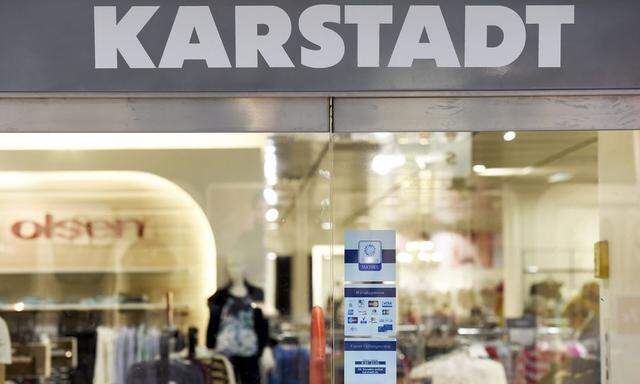 Closed doors with a slogan reading ' Warm Welcome ' are pictured at a Karstadt department store in Hamburg-Billstedt