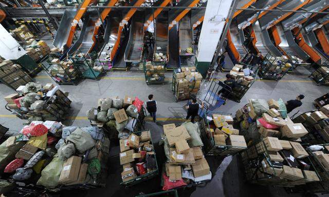 Employees sort parcels and boxes at a logistic centre of a postal service a day ahead of the Singles´ Day online shopping festival in Nanjing