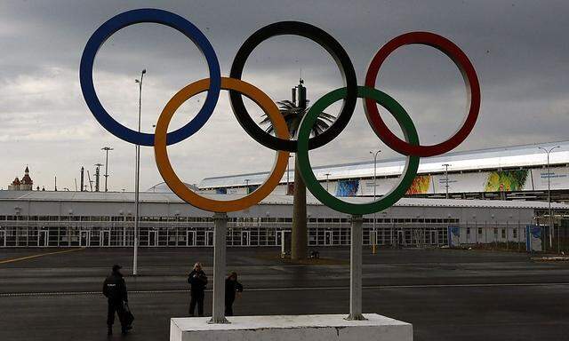 A police officer stands near Olympic rings at the Olympic Park in the Adler district of Sochi
