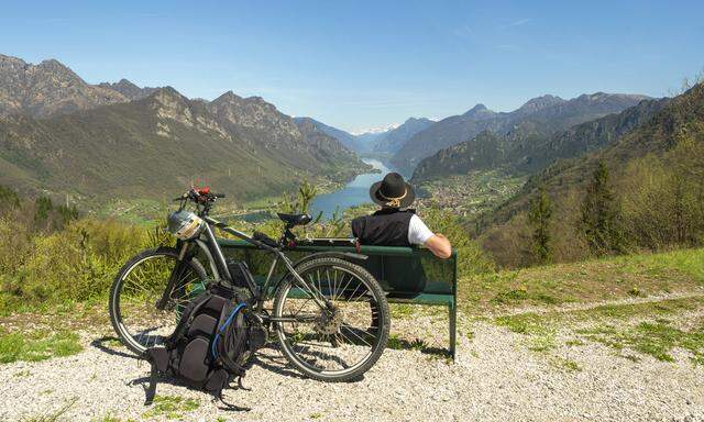 Italy Lombardy Senior hiker looking over Idro lake Adamello Alps Parco Naturale Adamello Brenta