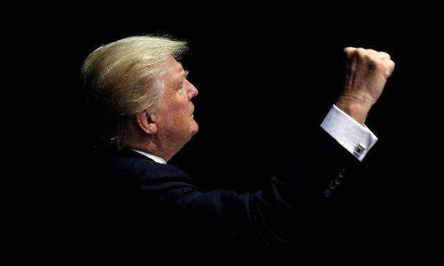 Republican presidential nominee Donald Trump gestures to supporters as he departs a campaign rally in Clive