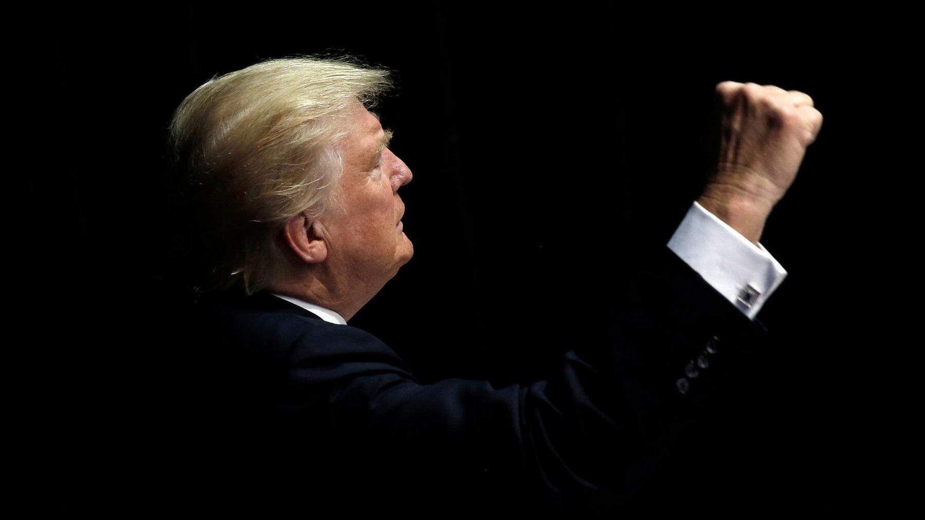 Republican presidential nominee Donald Trump gestures to supporters as he departs a campaign rally in Clive