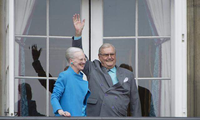 Denmark´s Queen Margrethe and Prince Henrik wave from the balcony during Queen Margrethe´s 76th birthday celebration at Amalienborg Palace in Copenhagen