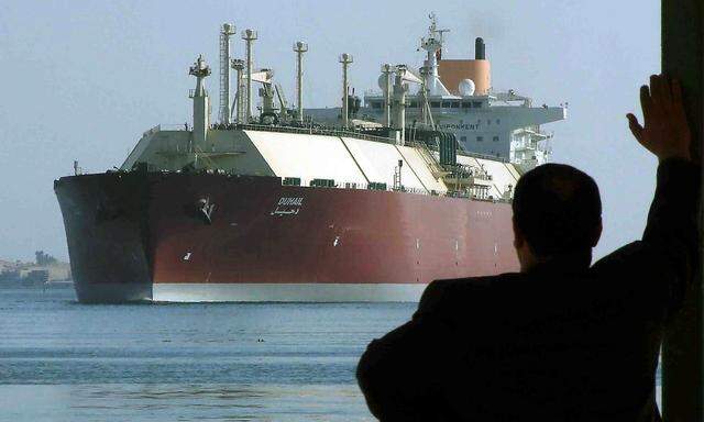 FILE PHOTO: A man looks as the world's biggest Liquefied Natural Gas (LNG) tanker DUHAIL as she crosses through the Suez Canal