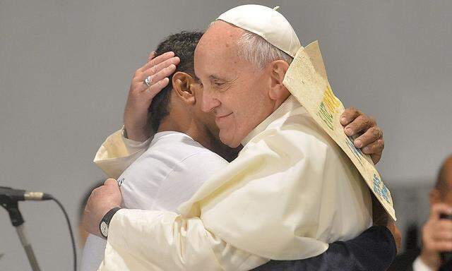 Pope Francis embraces a patient at the Hospital Sao Francisco (Saint Francis Hospital) in in Rio de Janeiro