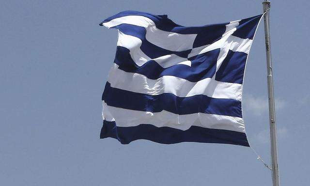 A Greek flug flutters at the top of the Acroplis hill in Athens