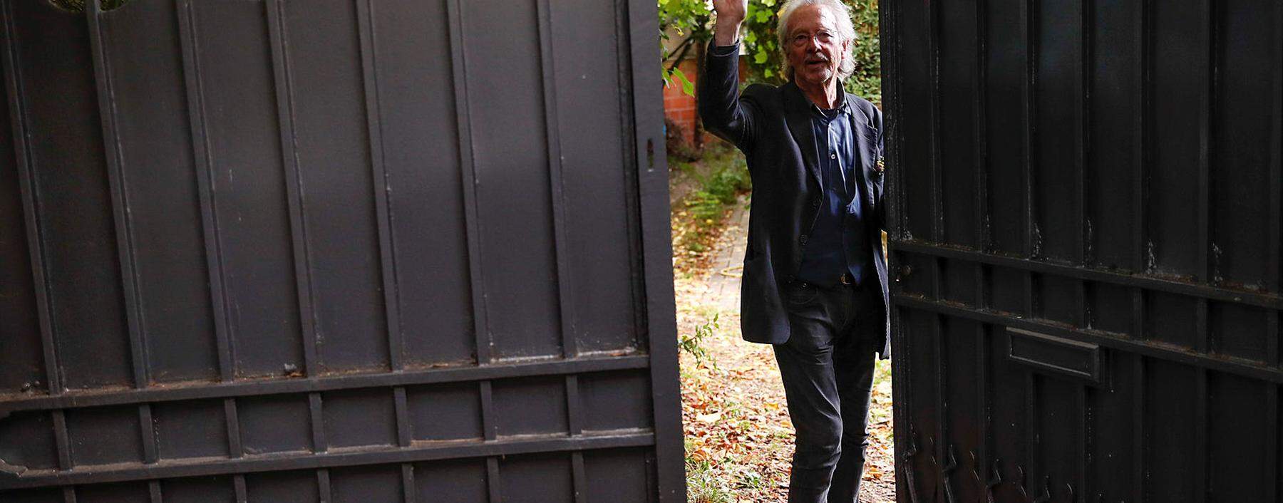 Austrian author Peter Handke gestures in his garden, following the announcement he won the 2019 Nobel Prize in Literature, in Chaville, near Paris
