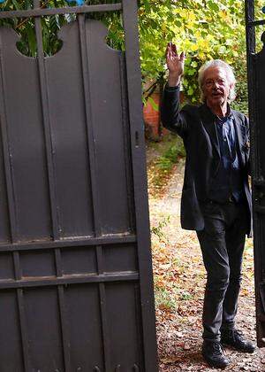 Austrian author Peter Handke gestures in his garden, following the announcement he won the 2019 Nobel Prize in Literature, in Chaville, near Paris