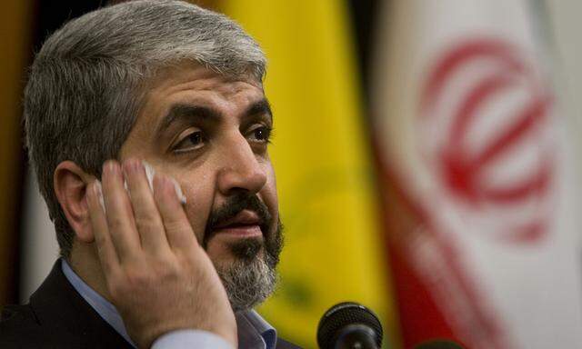 Hamas leader Khaled Mashaal removes the perspiration from his face as he attends ´The End of Israel´ conference at the technical college of Tehran´s university