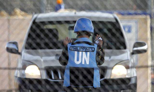 File photo of a Filipino U.N. peacekeeper directing a vehicle at the Kuneitra crossing on the Israeli occupied Golan Heights