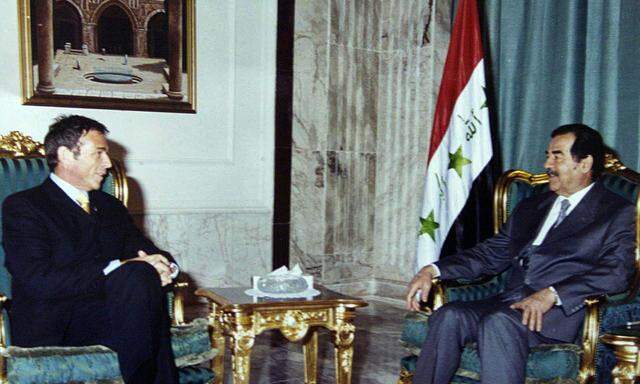 Iraqi Pesident Saddam Hussein (R) receives de facto leader of Austria´s Freedom Party Austria´s Joer..