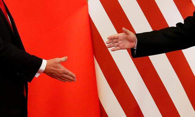 FILE PHOTO: U.S. President Donald Trump and China's President Xi Jinping shake hands after making joint statements at the Great Hall of the People in Beijing