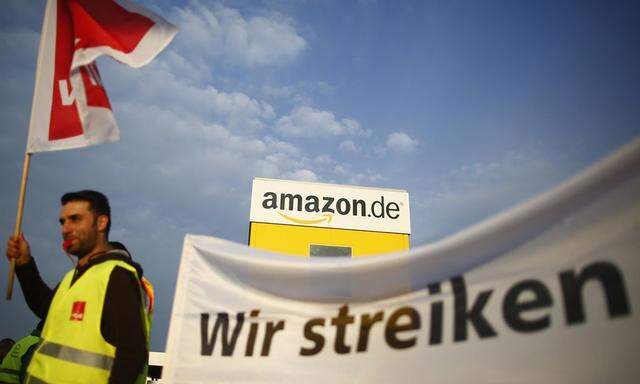 An employee of Amazon takes part in strike by German united services union Ver.di in front of Amazon warehouse in Bad Hersfeld