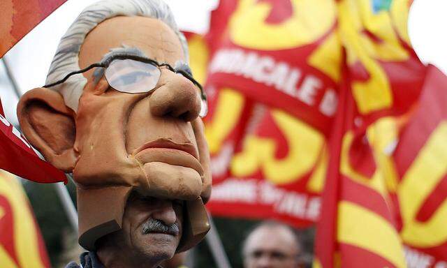Man wearing mask of Italy's PM Monti attends 'No Monti Day' demonstration against austerity policies in Rome