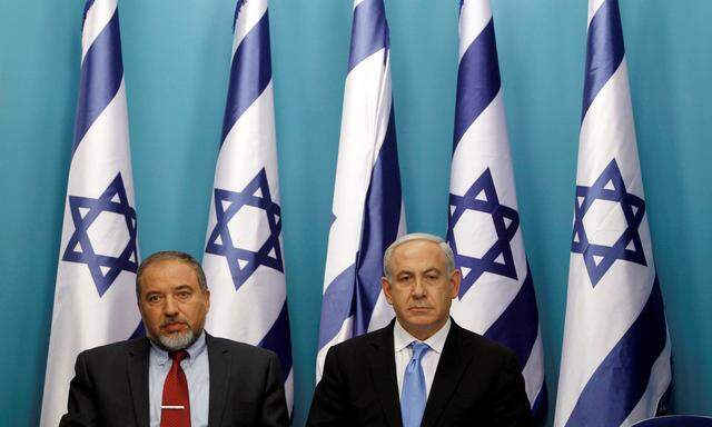 Israel´s Prime Minister Netanyahu sits next to Foreign Minister Lieberman after delivering a statement in Jerusalem