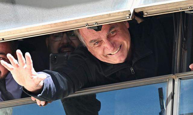 Jair Bolsonaro winkt seinen Anhängern in Brasilia von einem Fenster seiner Parteizentrale aus zu.