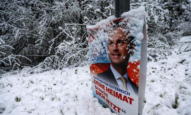 A banner of Austrian presidential candidate Norbert Hofer is covered with snow in Gnadenwald
