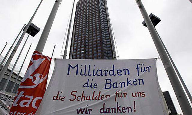 FILE - In this May 27, 2010 file photo banner reading: Billions for the banks - the debts for us - w