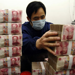 An employee counts Renminbi banknotes at a Bank of China branch in Changzhi