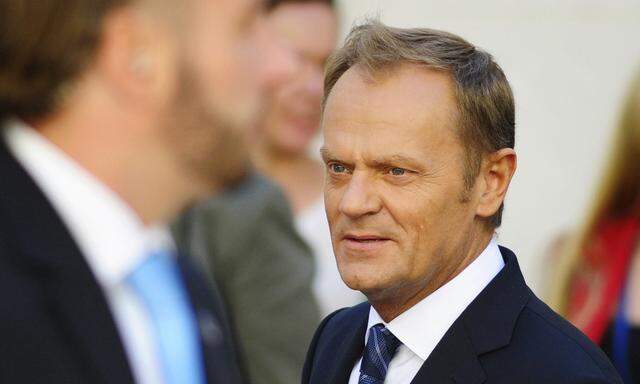 Poland´s PM Tusk walks outside the parliament in Warsaw