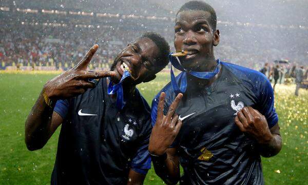 Paul Pogba und Samuel Umtiti präsentieren ihre Medaillen.