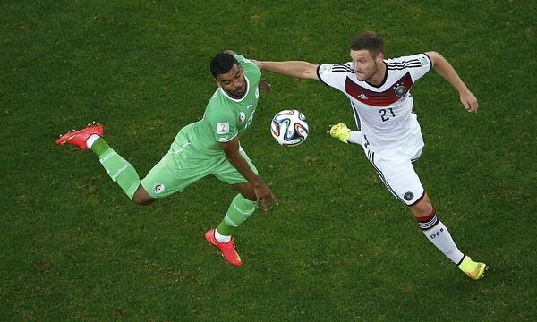 Algeria's Soudani fights for the ball with Germany's Mustafi during their 2014 World Cup round of 16 game in Porto Alegre