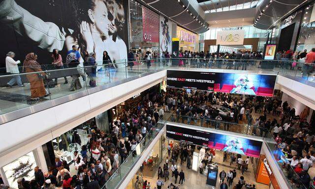 FILE PHOTO: Shoppers crowd the walkways on opening day of the Westfield Stratford City in east London
