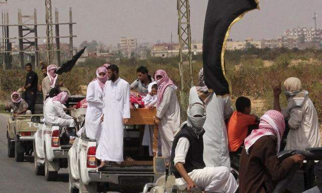 A funeral convoy carrying the bodies of four Islamist militants, drives through Sheikh Zuweid, in the north of the Sinai peninsula