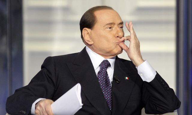 Italy's former Prime Minister Silvio Berlusconi gestures as he appears as a guest on the RAI television show Porta a Porta (Door to Door) in Rome