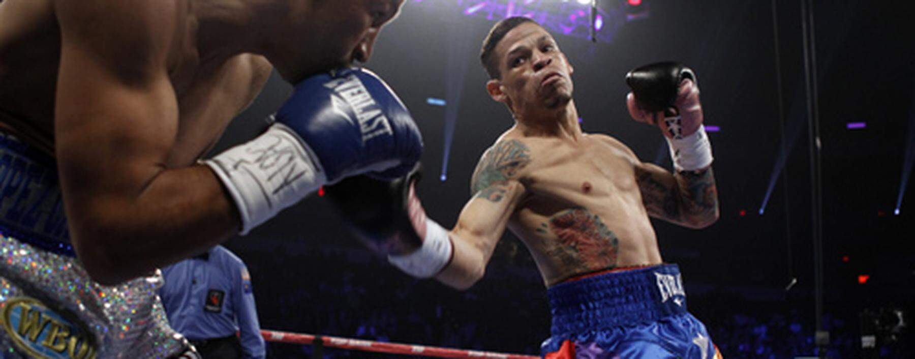 Cruz throws a punch at Salido of Mexico during their fight for a vacant WBO title at the Thomas &amp; Mack Center in Las Vegas