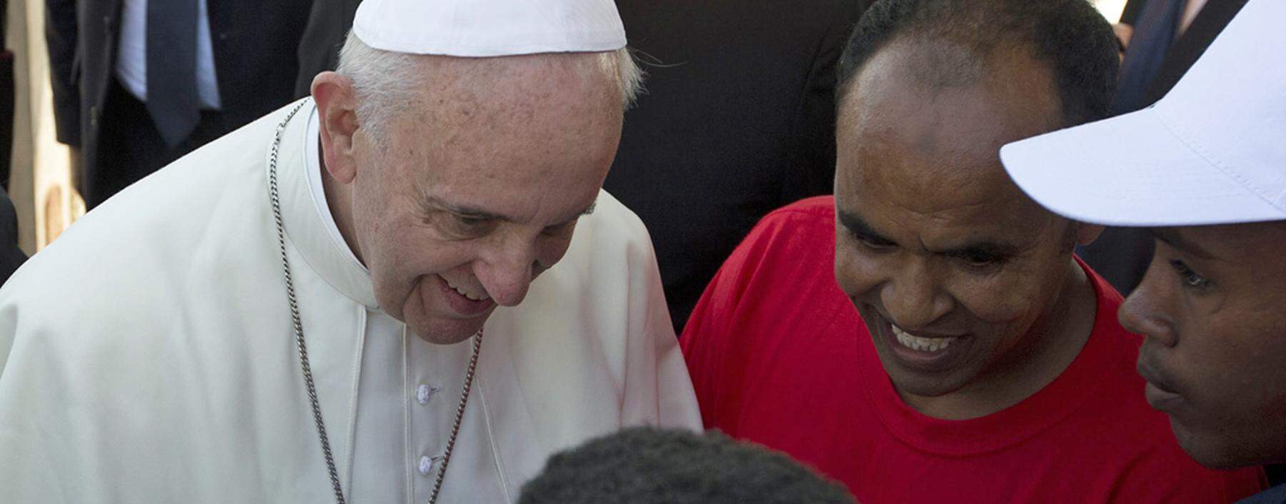 Pope Francis talks with migrants at Lampedusa Island