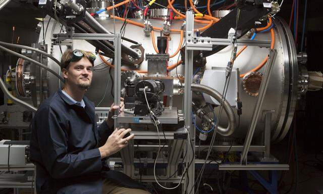 Tom McGuire stands next to the compact fusion reactor experiment inside his lab at the Skunk Works in Palmdale