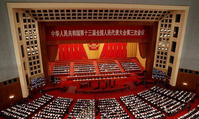 FILE PHOTO: Officials and delegates attend the opening session of NPC in Beijing