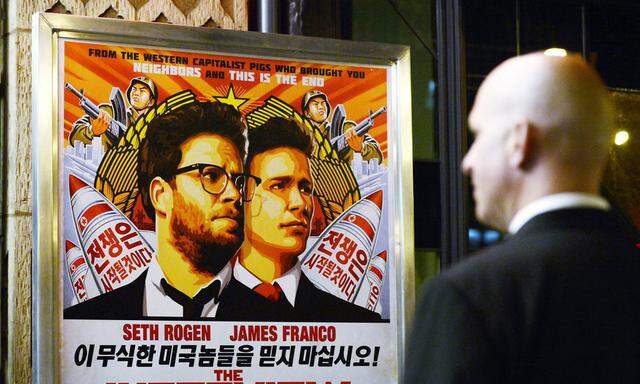 File photo of a security guard standing at the entrance of United Artists theater during the premiere of the film ´The Interview´ in Los Angeles