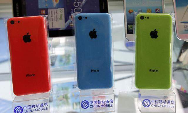Apple´s iPhone 5Cs are displayed on racks bearing the logo of China Mobile in Beijing