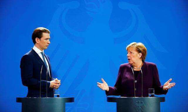 German Chancellor Angela Merkel and her Austrian counterpart Sebastian Kurz attend a news conference after talks at the Chancellery in Berlin