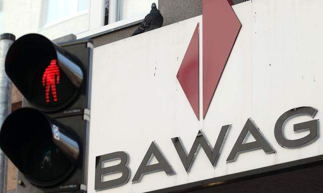 A pigeon sits atop the logo of Austrian lender BAWAG PSK next to traffic lights at a branch office in Vienna