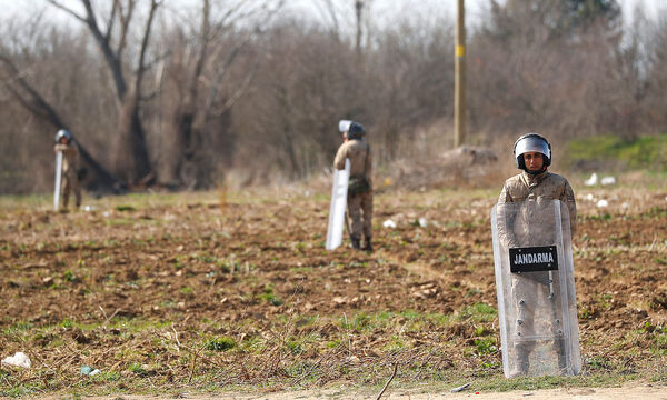 Turkish military members stand near Turkey's Pazarkule border crossing with Greece's Kastanies, near Edirne