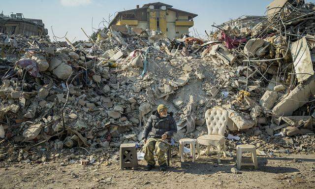 February 20, 2023, Antakya, Hatay, Turkey: A man guards th ruins of the destroyed buildings in Antakya after the massive