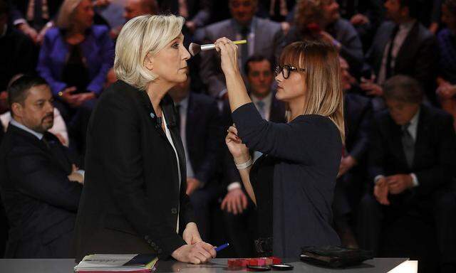 Candidate for the 2017 presidential election Marine Le Pen, French National Front (FN) political party leader, gets make-up before a debate organised by French private TV channel TF1 in Aubervilliers